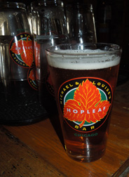 Hopleaf Bar pint glass with dark beer and logo, circa 2012